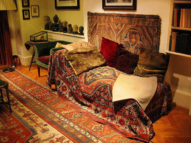 Sigmund Freud's Couch Sigmund Freud's couch draped with antique tribal rugs - Nazmiyal