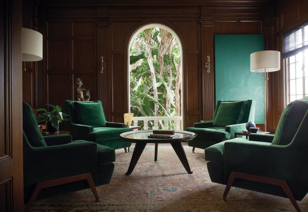 The Santa Monica's library, featuring a 17th century rug with green velvet armchairs. Smith Library