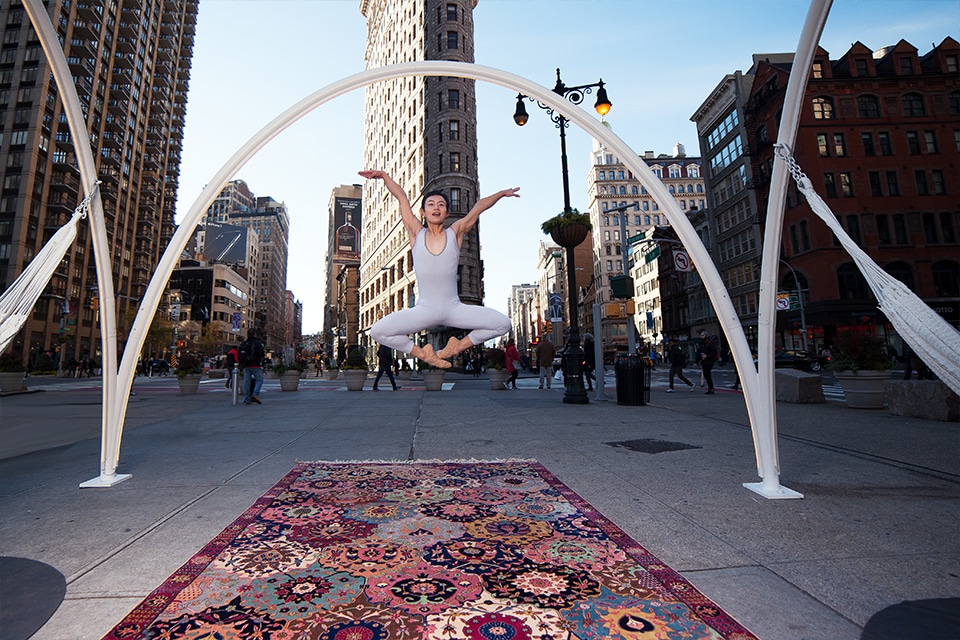 A ballet dancer jumps and poses by Flatiron building NYC on top of Nazmiyal antique rugs NYC antique rug photography project - A ballet dancer jumps and poses by Flatiron building NYC on top of Nazmiyal antique rugs