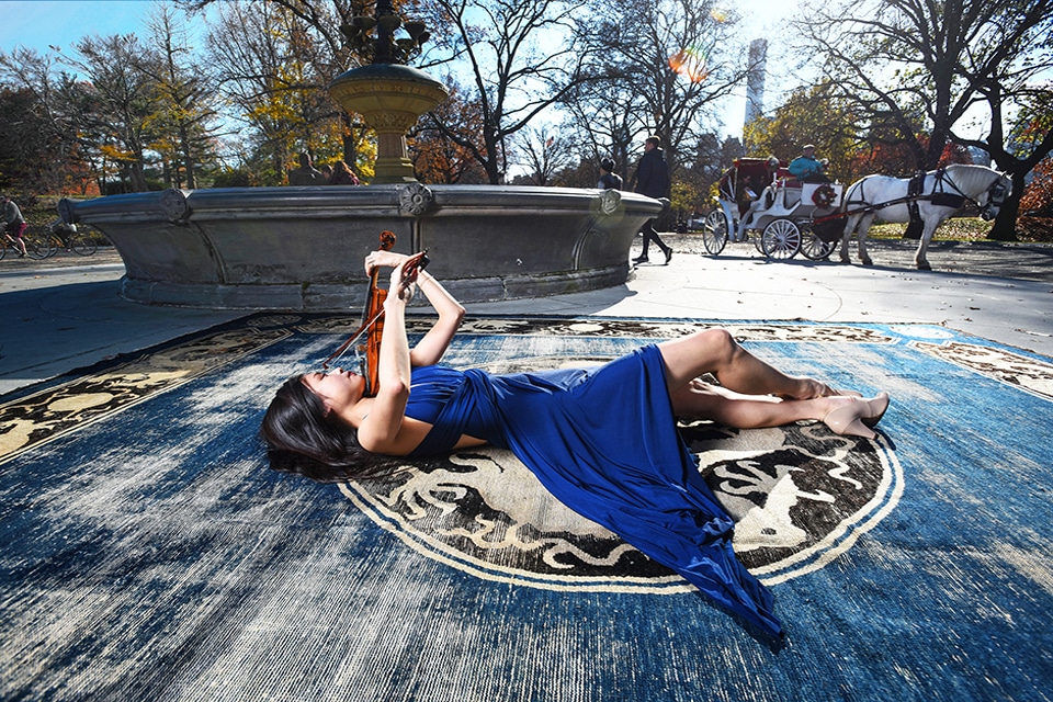 Violinist in Central Park on a 19th Century Antique Ningxia Carpet by Nazmiyal Antique Rugs in Central Park NYC A violinist relaxes on top of a 19th century NingXia carpet from Nazmiyal Antique Rugs by a fountain in Central Park, NYC