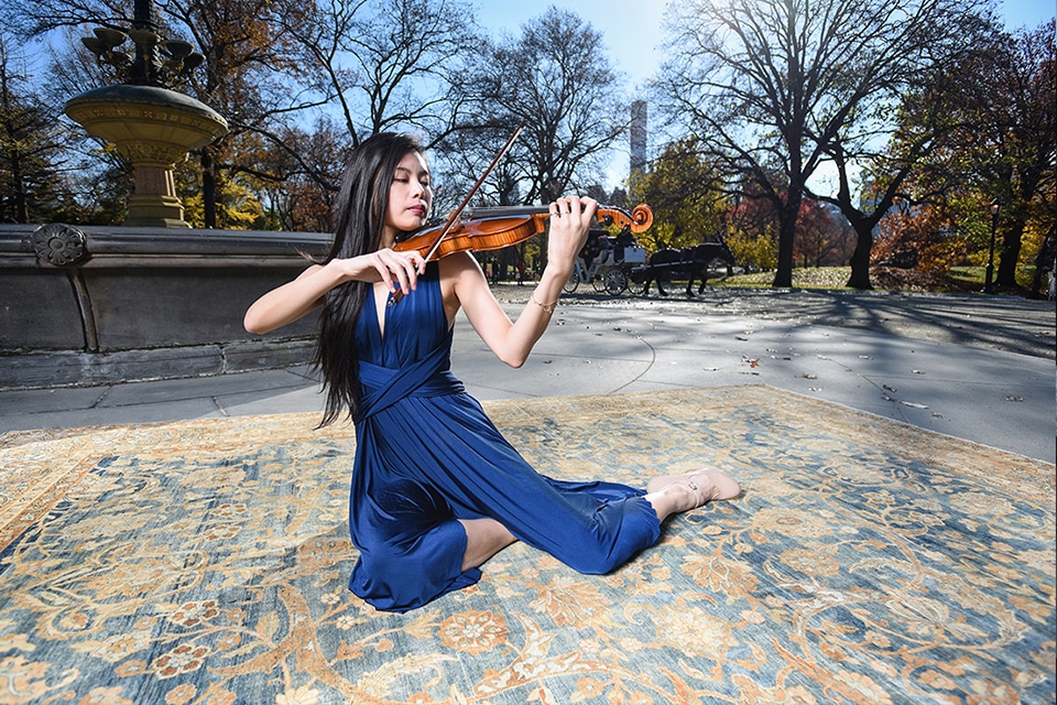 A Violinist Performs On Top Of An Antique Kerman Carpet By Nazmiyal Antique Rugs in Central Park NYC A Violinist Performs On Top Of An Antique Kerman Carpet By Nazmiyal Antique Rugs in Central Park NYC