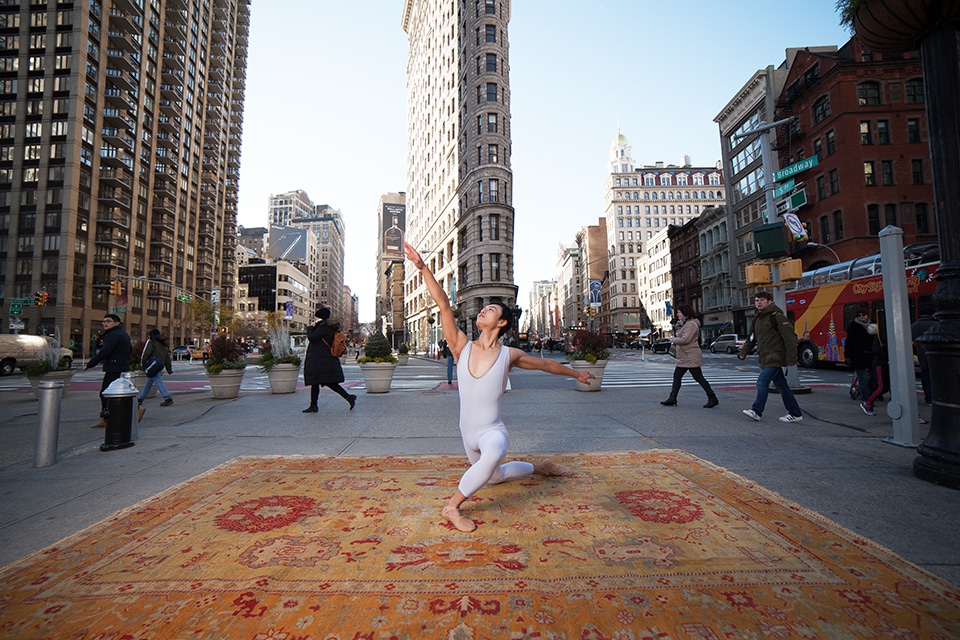 Ballet dancer by Flatiron building on a Antique Oushak Rug by Nazmiyal Antique Rugs A ballet dancer poses on top of an antique Oushak rug from Nazmiyal Antique Rugs by the Flat Iron building NYC